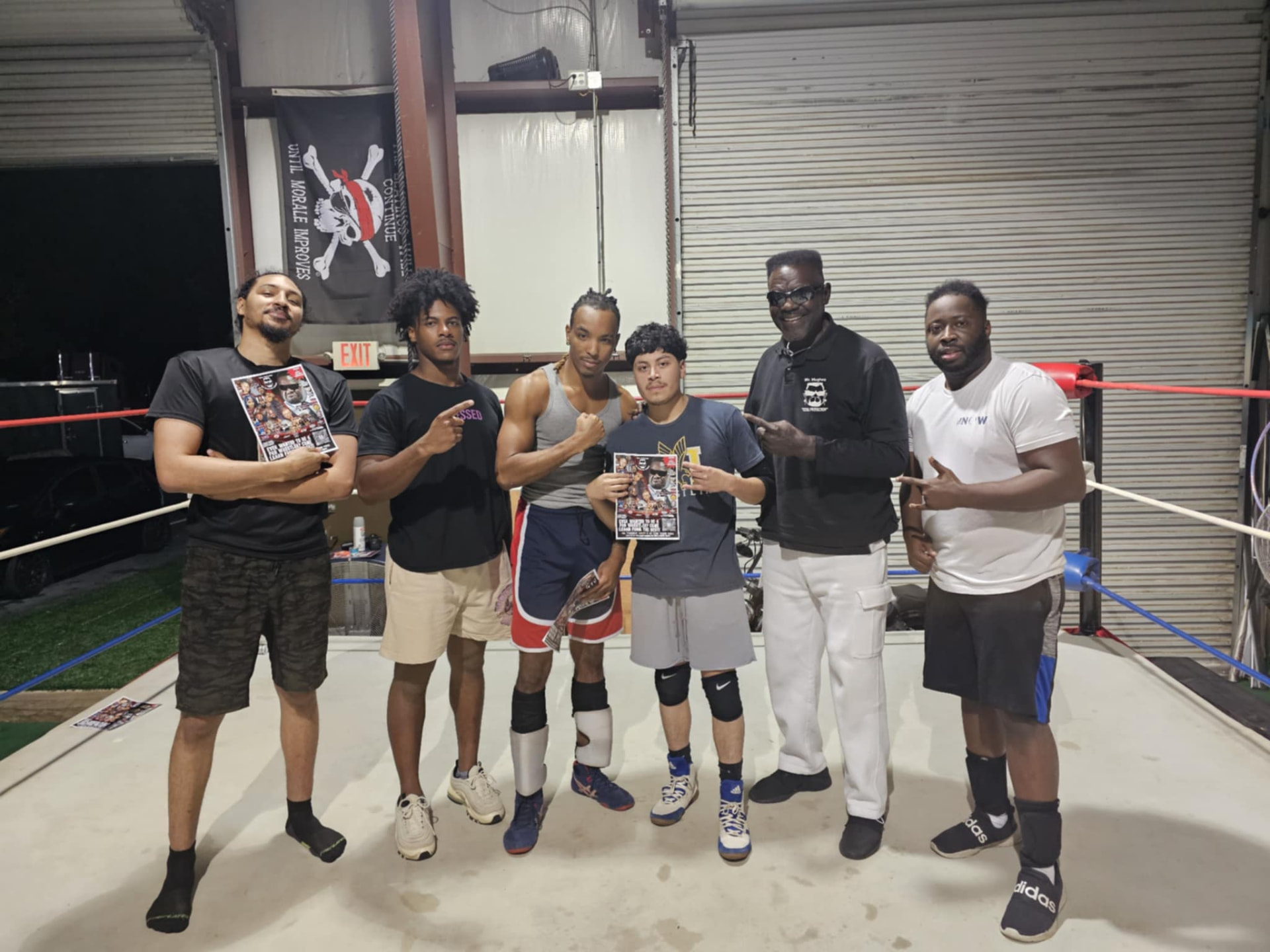 Josh Bell with wrestlers at a training facility